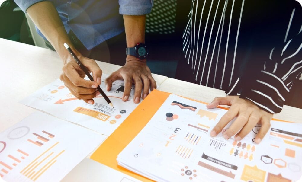 CMA 자격증 취득을 위한 CMA 자격요건 가이드 1 two people having a business meeting with a pencil and paper reports