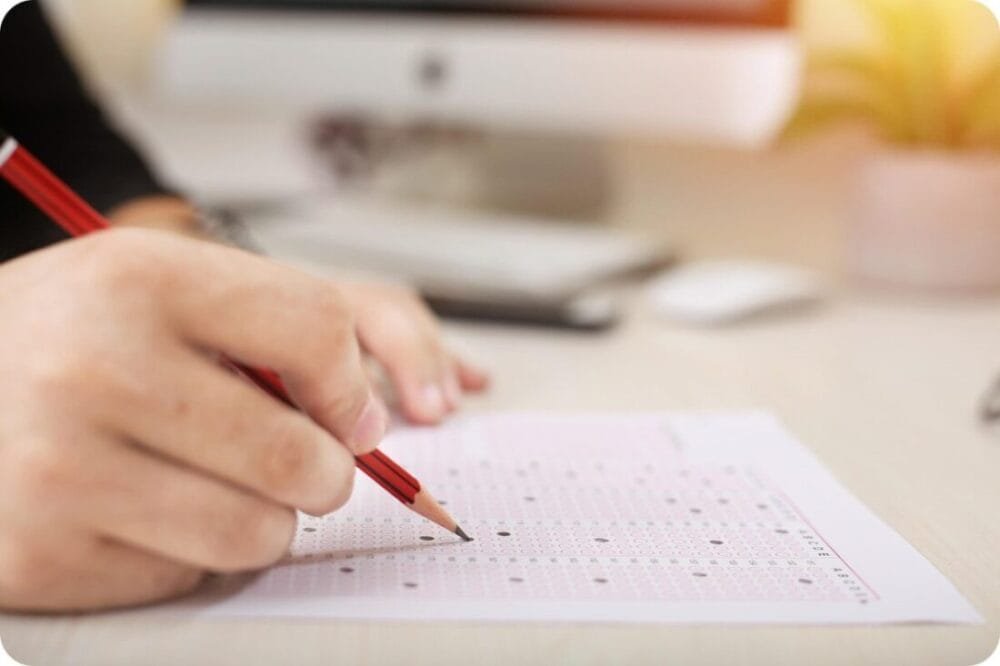 Taking an exam with a pencil on a white paper for multiple choice questions