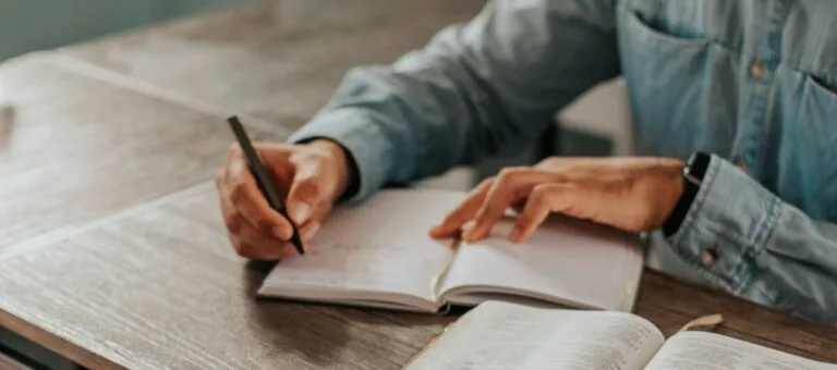 Studying for an Exam writing on a notebook