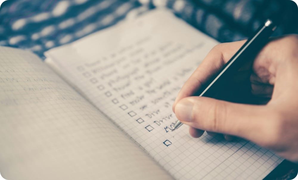 writing a to do list on a paper